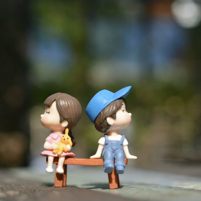 boy and girl sitting on bench toy